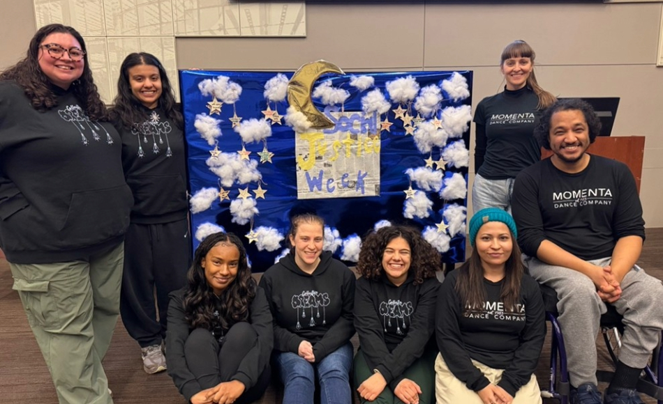 A diverse group of people poses for a picture in front of a banner at a CSIB gathering.